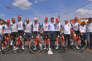 Lotto Soudal riders and staff arm-in-arm at the start of a neutralised stage 4 at the Tour de Pologne in memory of Bjorg Lambrecht