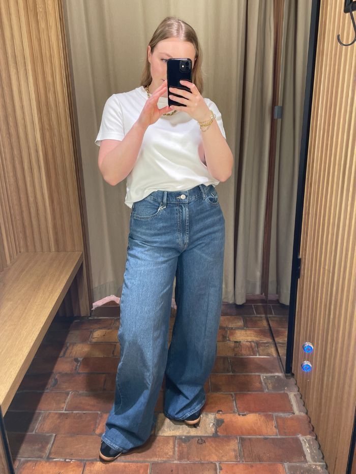 Woman wears white t-shirt and blue jeans