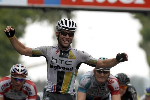 Cavendish celebrates as his rivals look on