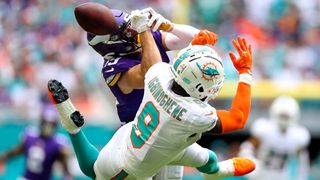 Adam Thielen #19 of the Minnesota Vikings attempts to catch a pass over Noah Igbinoghene #9 of the Miami Dolphins during the third quarter at Hard Rock Stadium on October 16, 2022 in Miami Gardens, Florida.