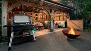 The covered outdoor seating area with BBQ and firepit at Hall Farm