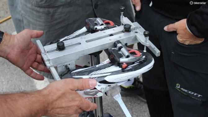 First, the old pair of shoes is clipped into the pedals, and a system of Allen bolts are dialed in
