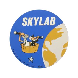 decal for nasa's skylab program showing characters from johnny hart's 'wizard of id' comic peering at earth and the heavens from an orbiting platform