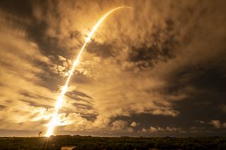 a rocket leaves a streak of light in the dark sky