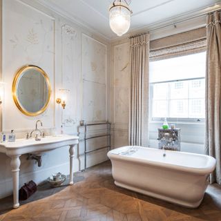 old queen street exterior beauchamp estates ensuite bathroom with picturesque parquet flooring white bath tub white wash basin and round mirror