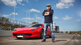 Brian Johnson standing next to a Ferrari