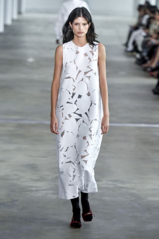 a model wears a cutout dress on the tibi runway