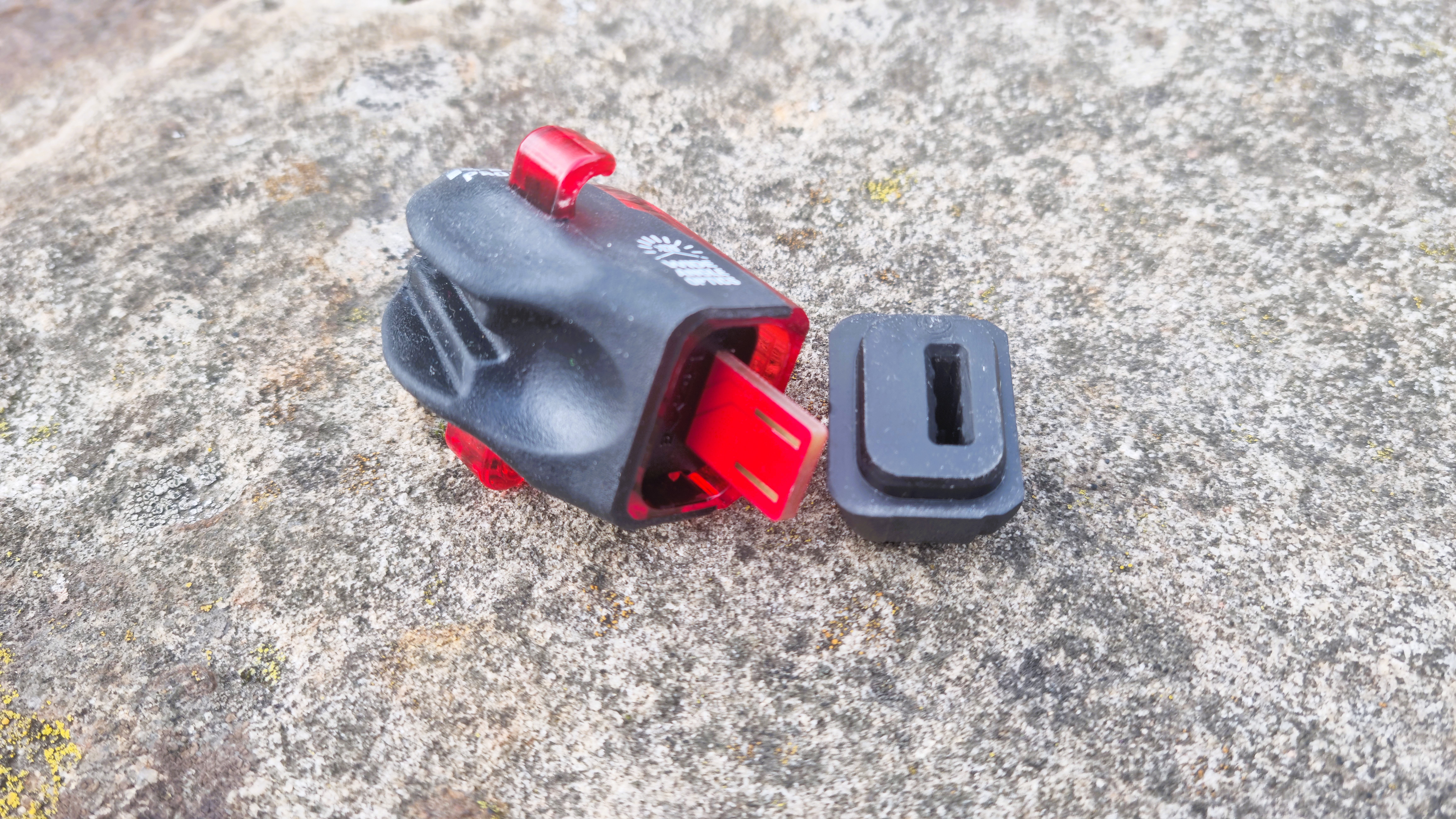 The Lezyne KTV Drive Pro+ dismantled, showing the USB charging bung