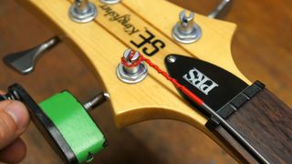 Winding strings on to a bass guitar tuning post