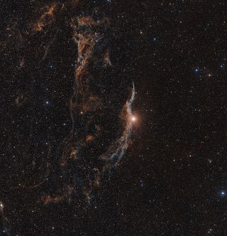 The Veil supernova remnant and the surrounding sky appear in this image.