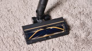 A black and gold Dreame R10 Pro cordless vacuum cleaner