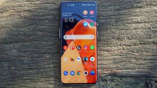 A OnePlus 9 Pro from the front, with the screen on