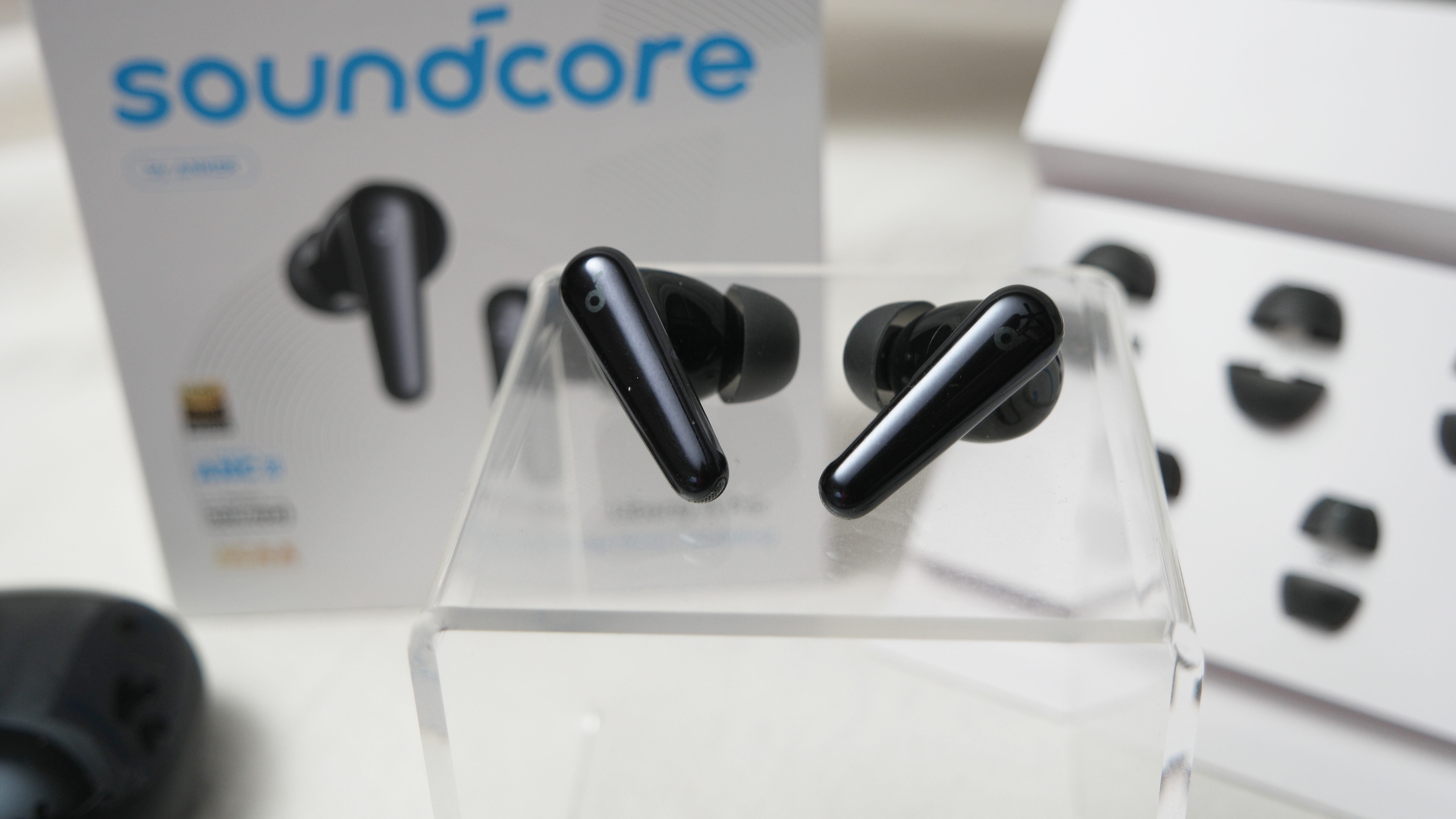 Soundcore Liberty 4 Pro earbuds on an acrylic pedastal