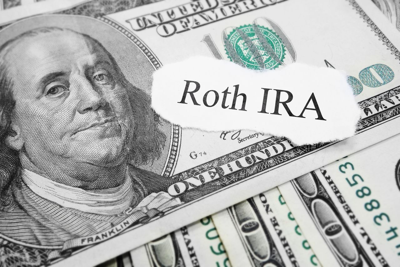 Roth IRA paper message on hundred dollar bills.