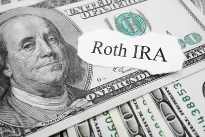 Roth IRA paper message on hundred dollar bills.