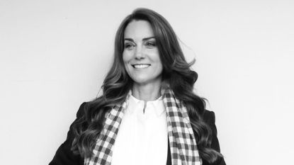 A black and white photo of Kate Middleton wearing a white shirt and checkered scarf with black blazer