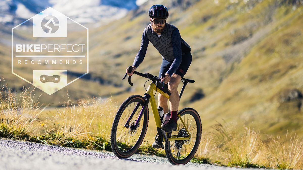 A gravel rider climbing up a gravel road in the alps