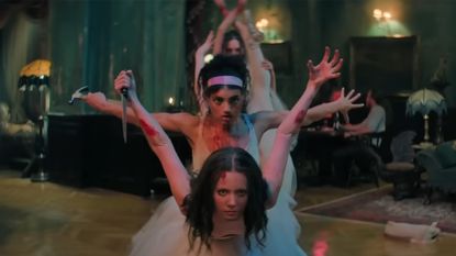 A group of blood soaked ballerinas posing with improvised weapons