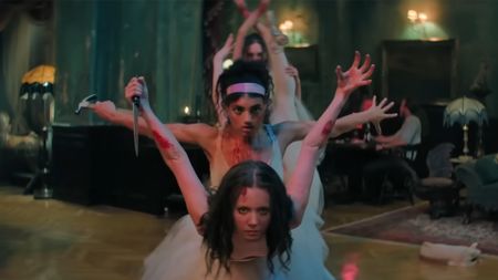 A group of blood soaked ballerinas posing with improvised weapons