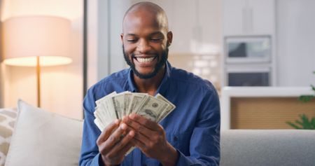 Man holding a stack of cash.