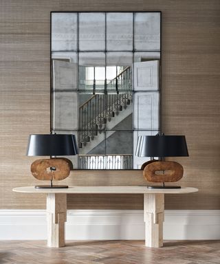 Hallway with neutral textured wallpaper and console