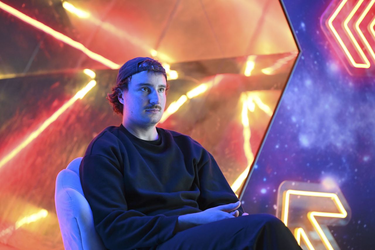 Nikon ZR sample images &ndash; man seated infront of neon lit wall