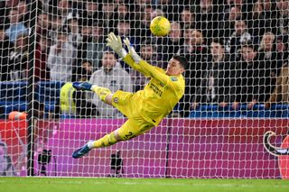 Djordje Petrovic of Chelsea saves a penalty taken by Matt Ritchie of Newcastle United during a penalty shoot out in the Carabao Cup Quarter Final match between Chelsea and Newcastle United at Stamford Bridge on December 19, 2023 in London, England.