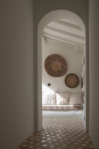 A living room with baskets on walls