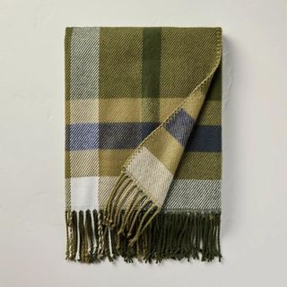 A green checkered throw blanket