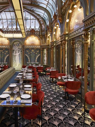 Beefbar restaurant interior, orange chairs, beige leather banquette seating