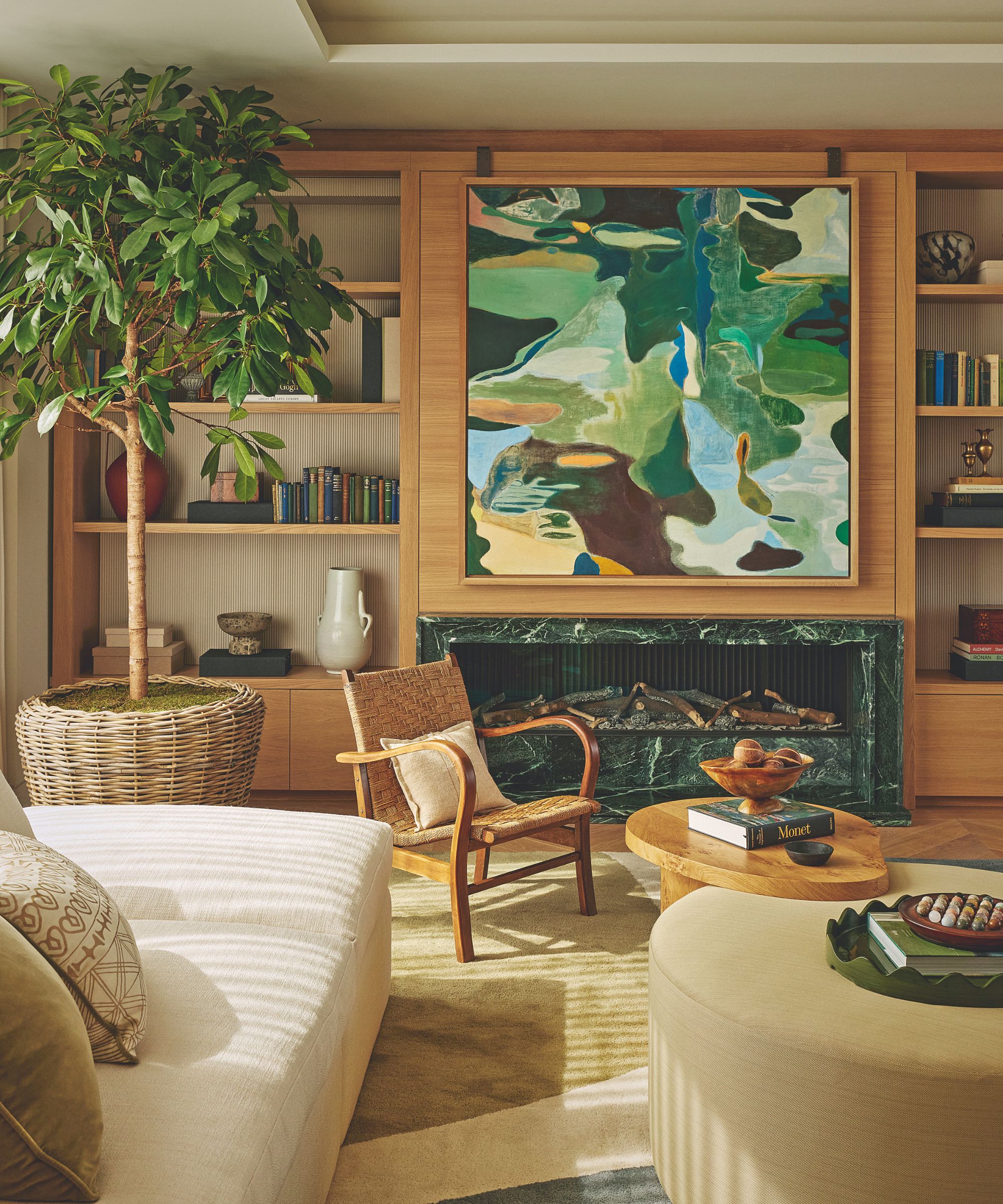 sitting room with inbuilt shelving and wooden walls and white sofa and artwork