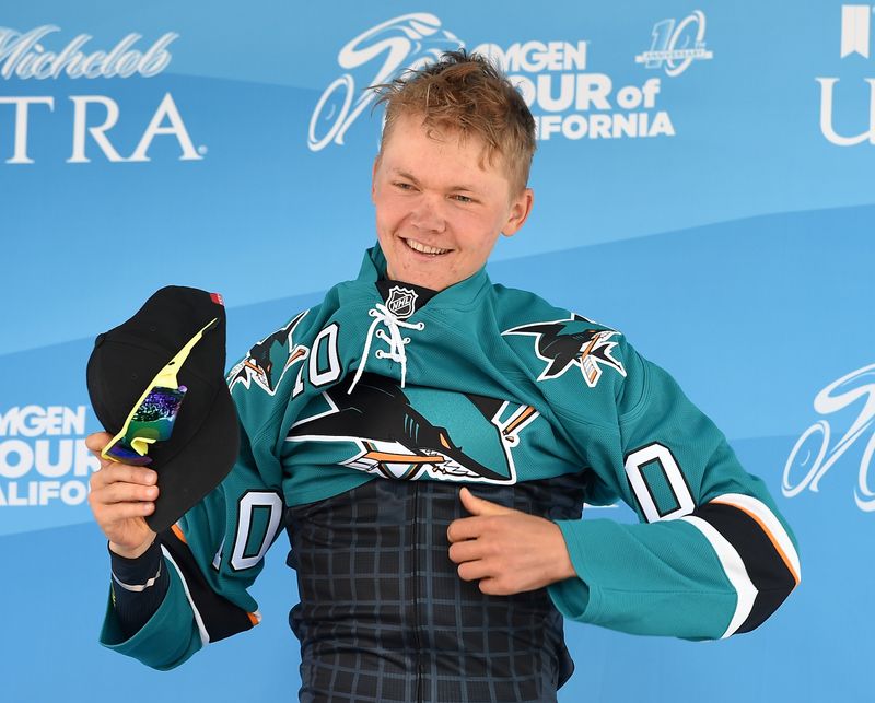 Toms Skujins (Hincapie Racing Team) pulls on a San Jose Sharks jersey after wining the stage in San Jose