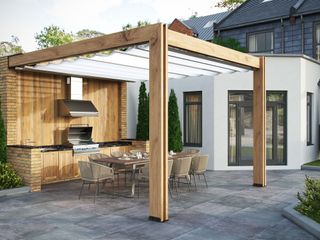 PAved patio with outdoor kitchen underneath a pergola