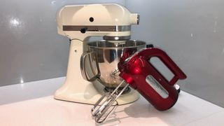 A stand mixer and hand mixer sitting on a kitchen countertop