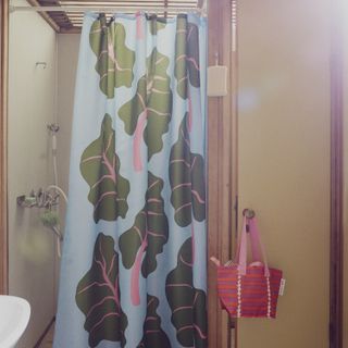 A shower room with a patterned shower curtain