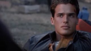 Antonio Sabàto Jr sitting outside with a cut on his head in Earth 2.