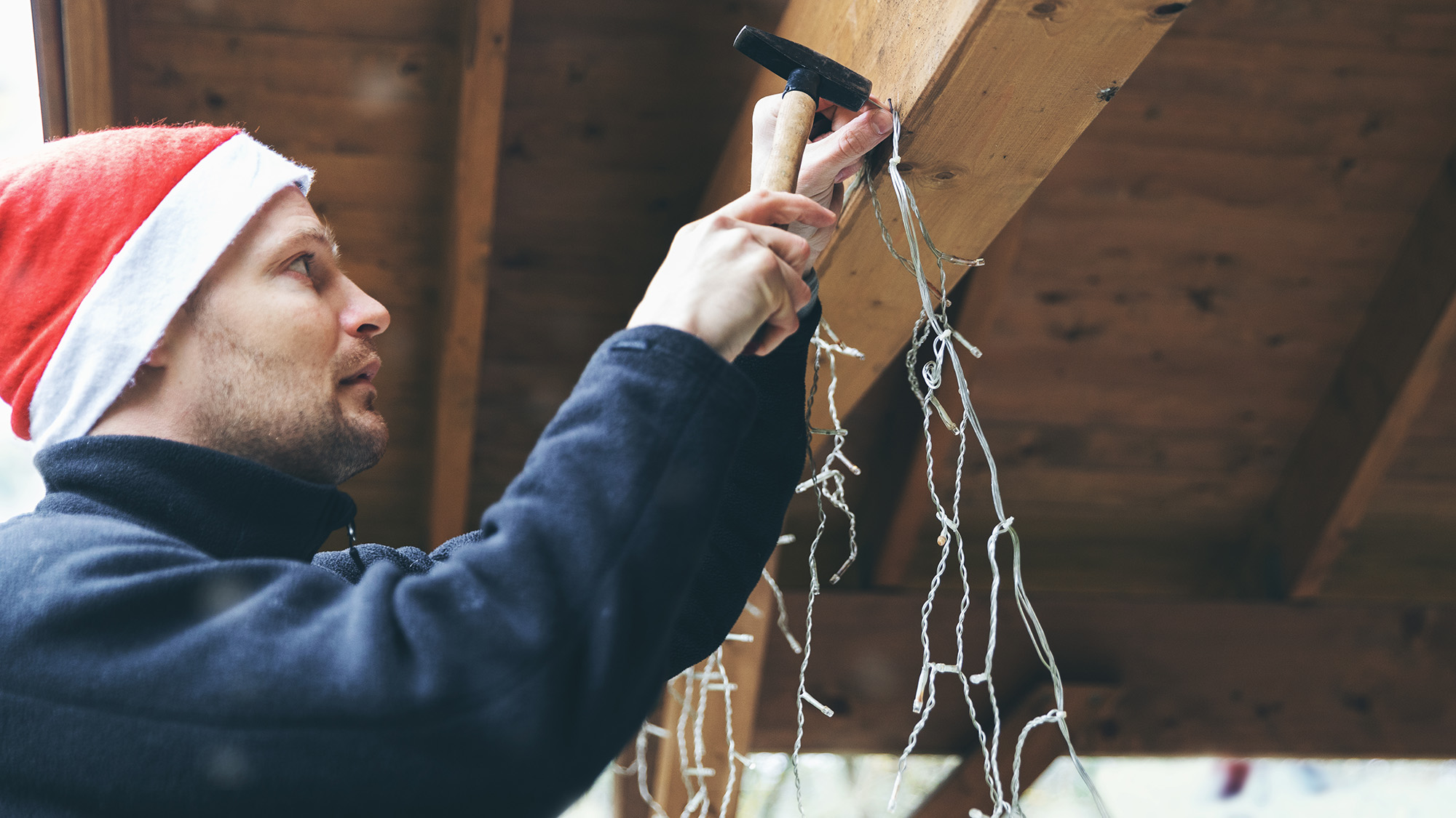 Man hanging holiday lights