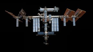 a space station hangs in black