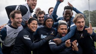 The AFC Richmond team celebrating. Dani, Bumbercatch, Issac, Sam and Jamie are all at the front with more of the team behind them.