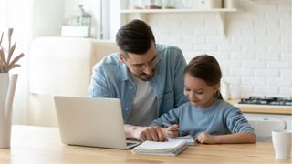 Dad and daughter using a laptop