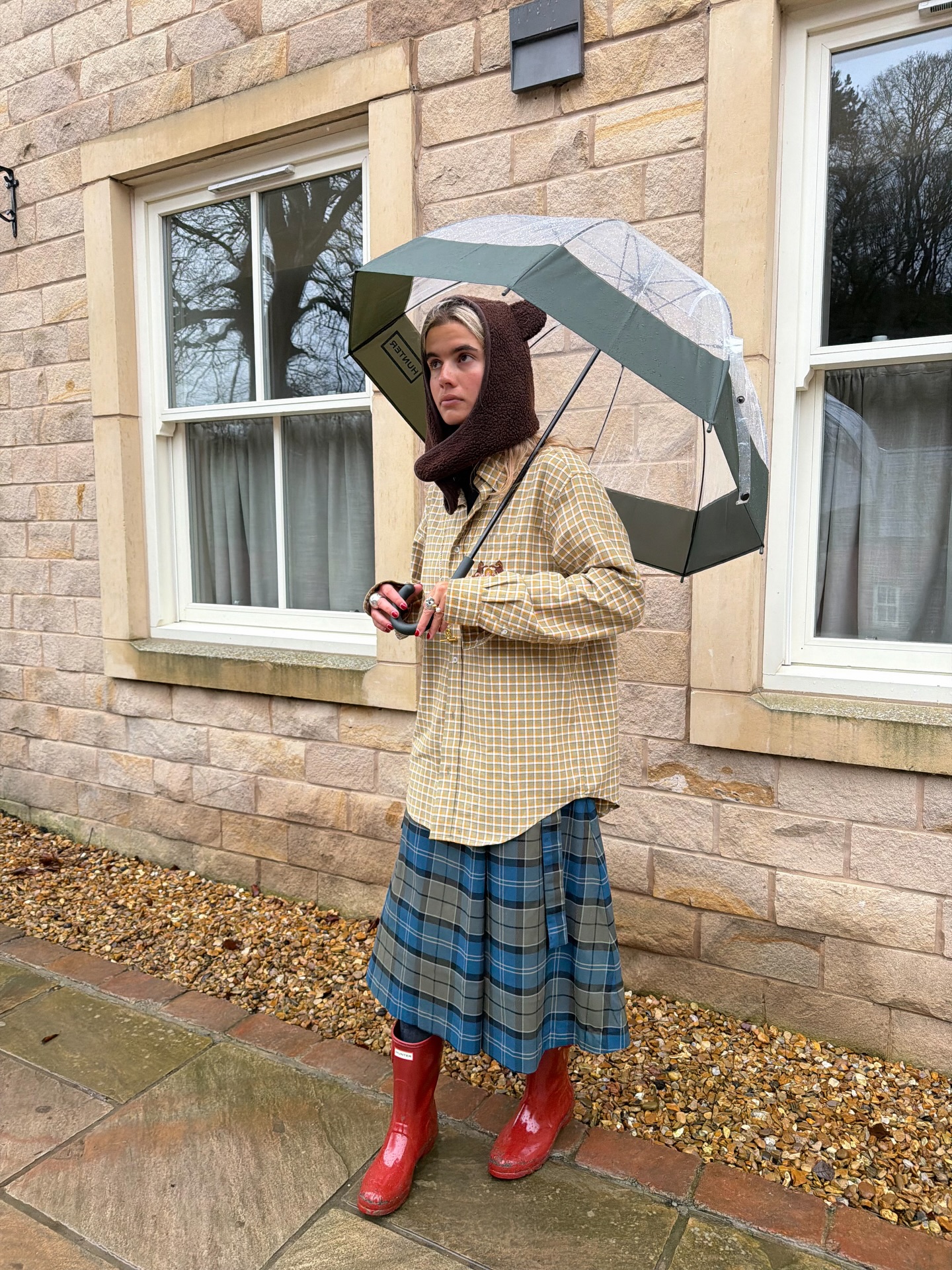 how to wear a kilt in 2026: Tori Van Breugel wears a check shirt, kilt skirt and red wellies