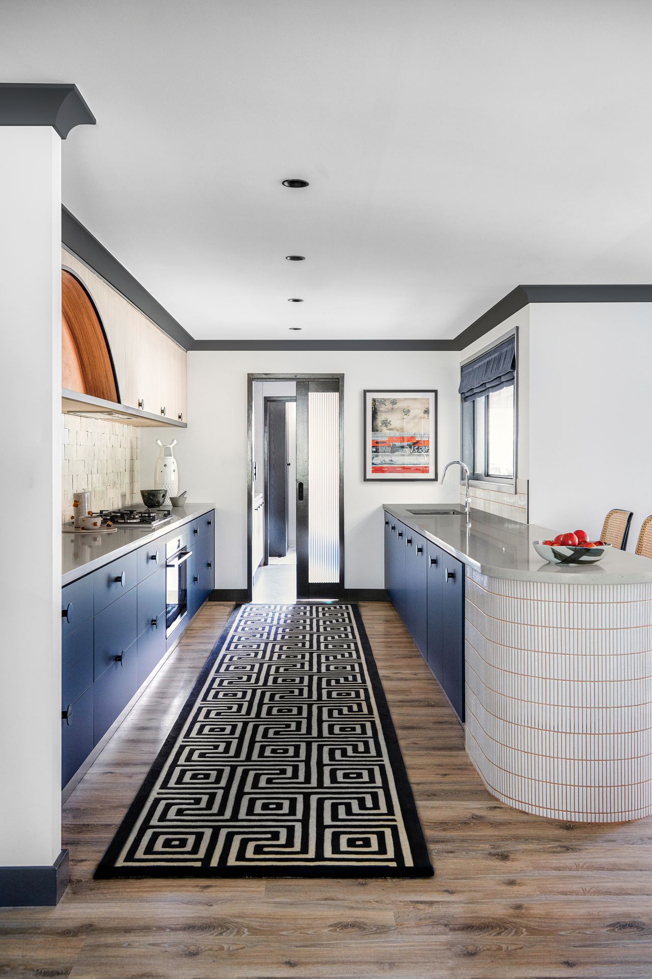 a modern kitchen with a tiled peninsula