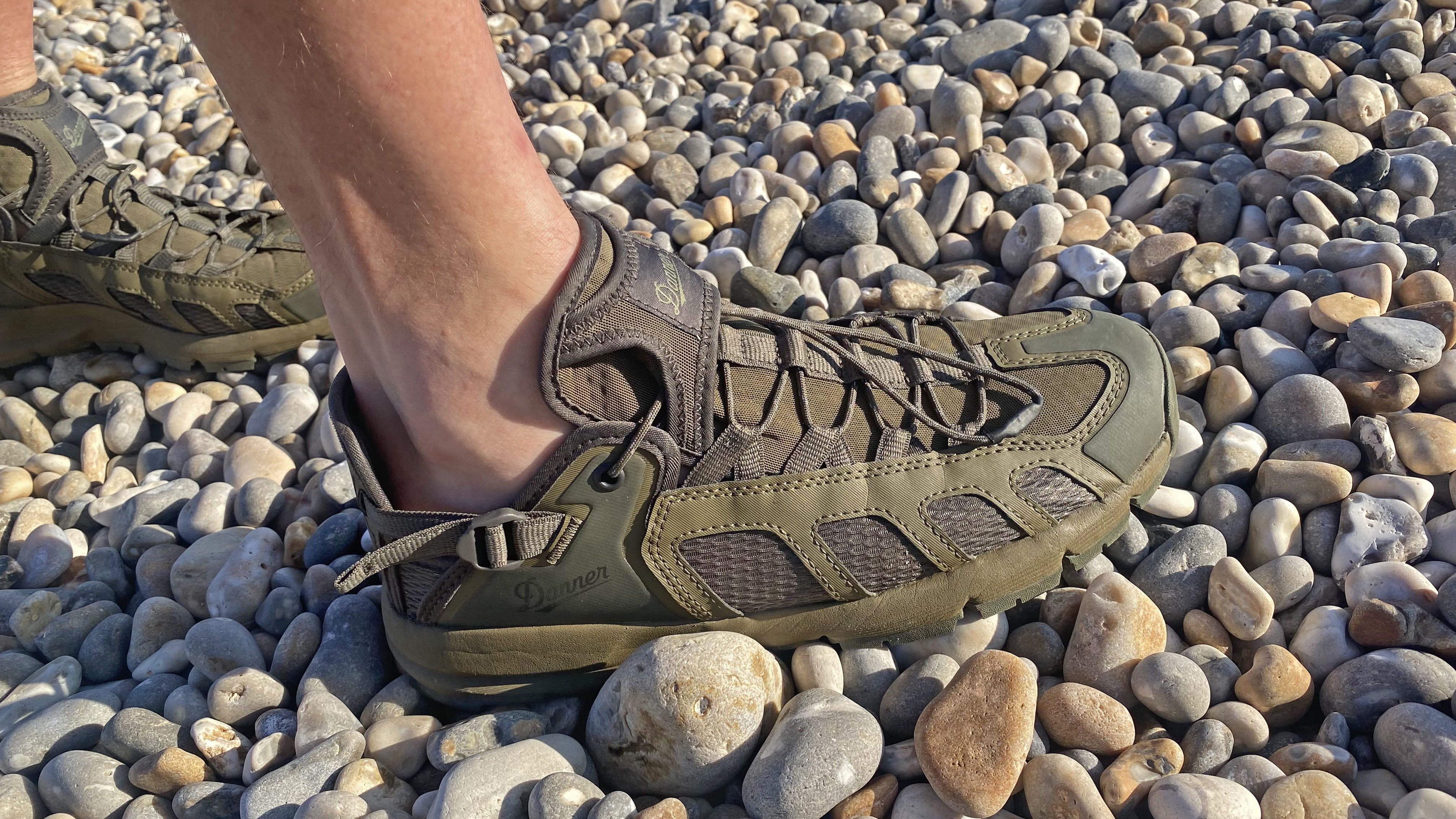 Walker wearing the Danner Fullbore Sandals on pebbles