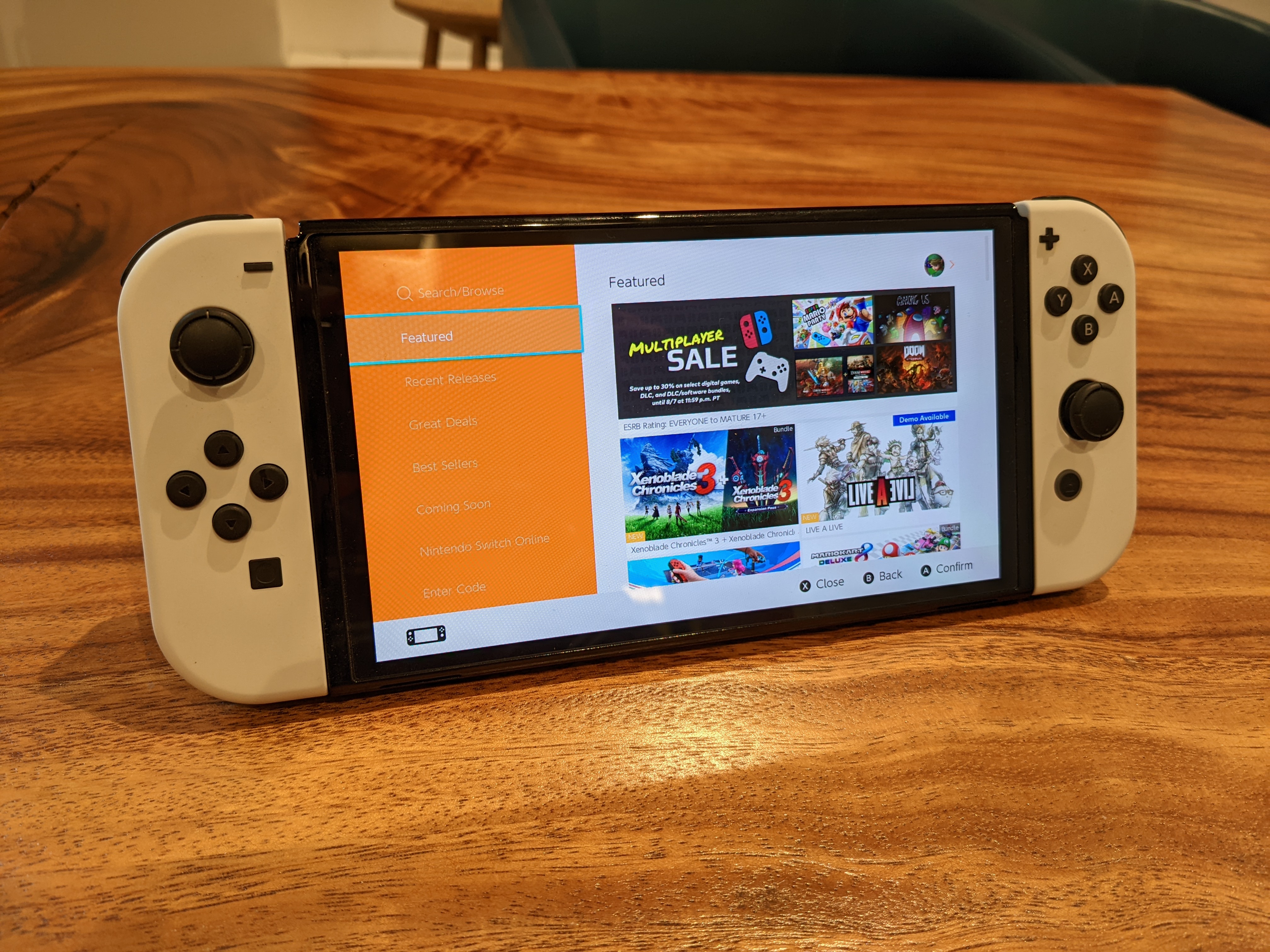 Switch on desk showing screen illustrating how to log into your Nintendo account and access the eShop to designate a new primary console.