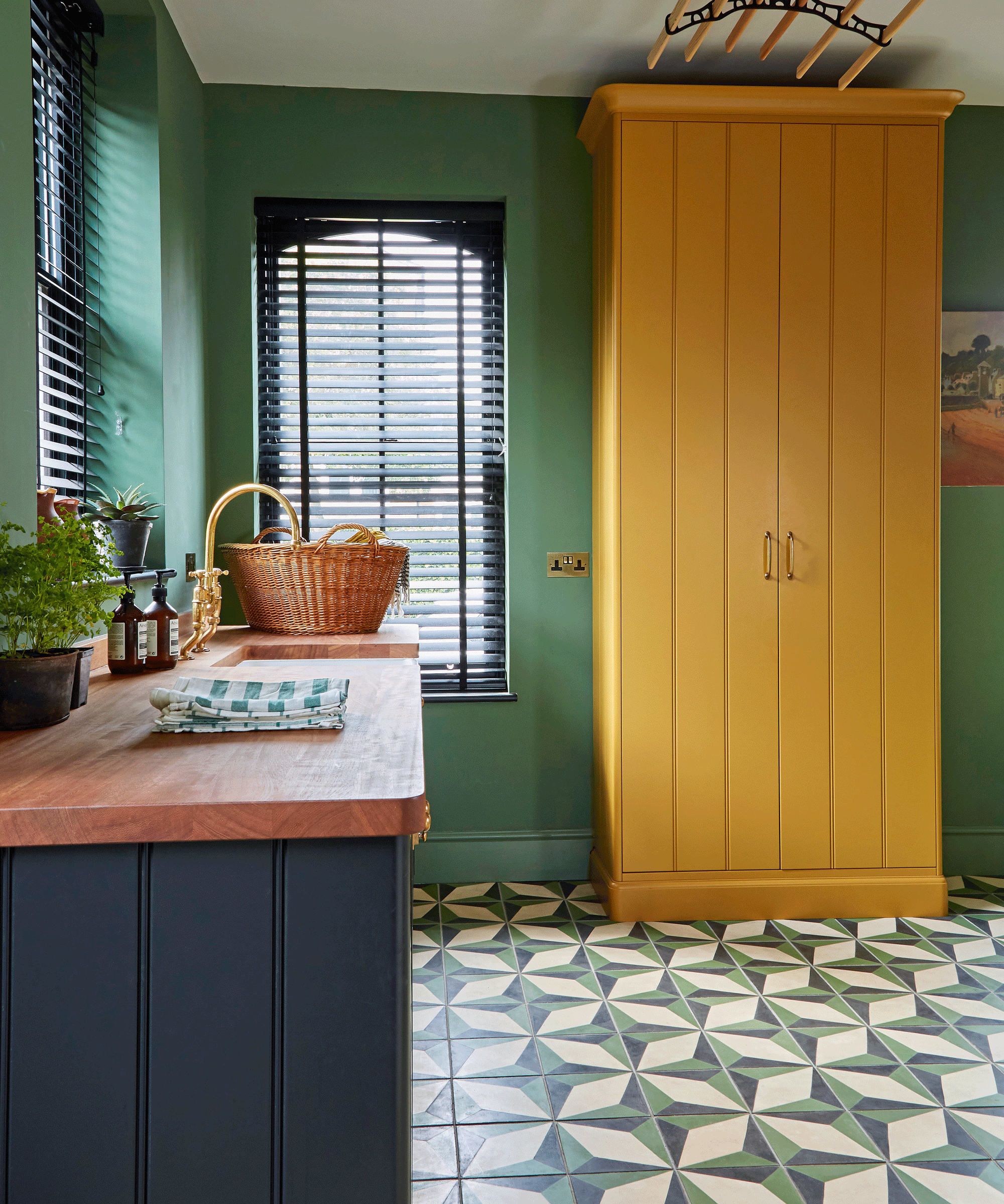 Colourful kitchen with yellow cabinet, green walls and tiled floor