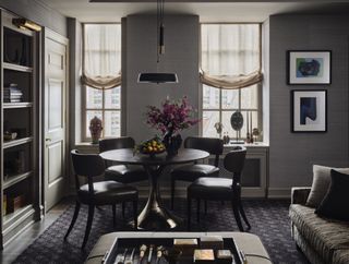 round dining table in dark living room by Jessica Lagrange