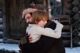 Michiel Huisman as Joel embracing Nikolas in 'A Boy Called Christmas'.