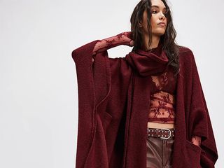 model wears lace top, deep red leather barrel pants, and deep red kimono with attached scarf