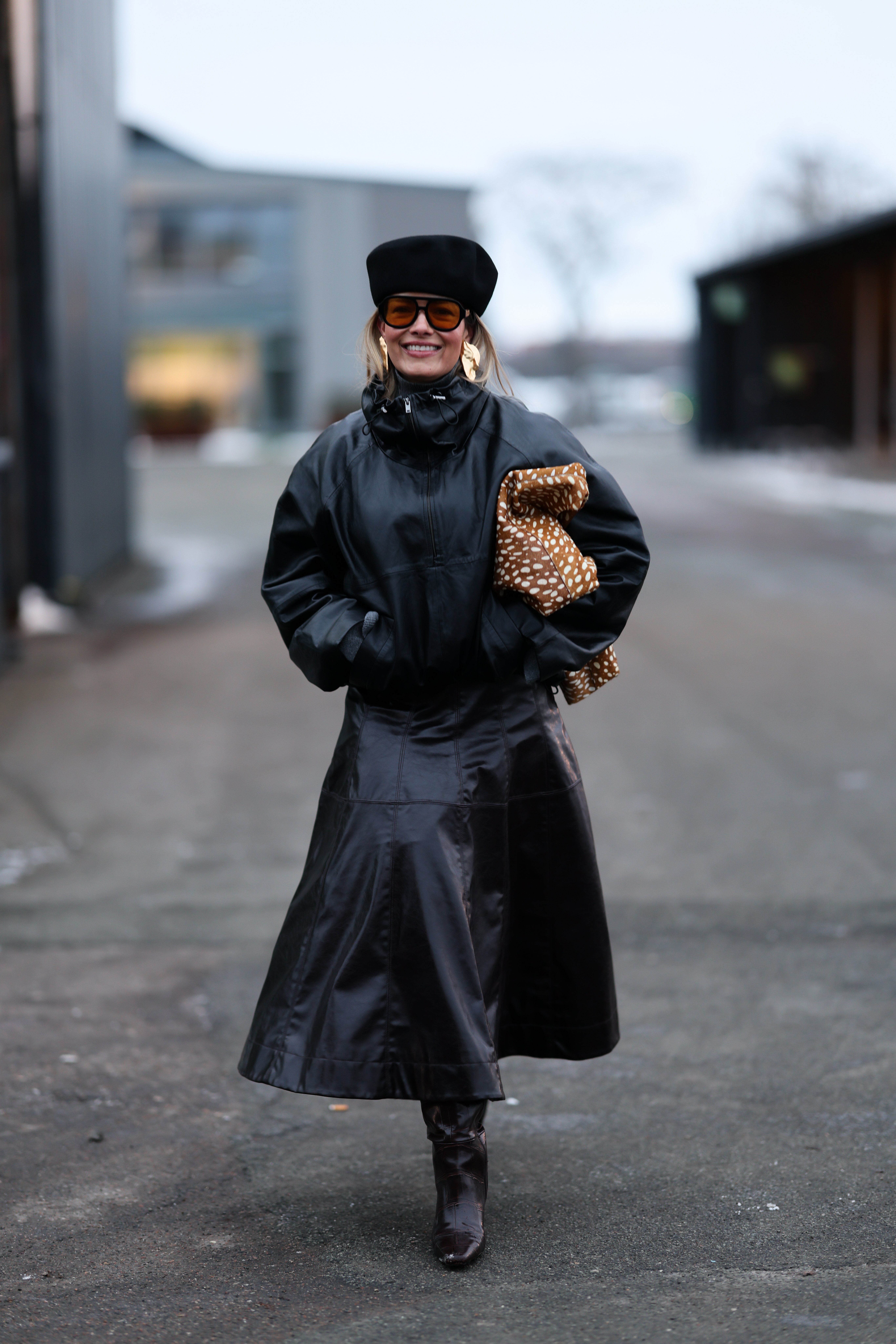 woman wearing all-black outfit skirt and shell jacket
