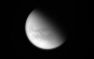 Floating high above the hydrocarbon lakes, wispy clouds have finally started to return to Titan's northern latitudes.